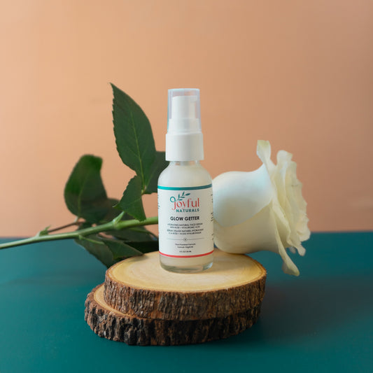 Hydrating face serum bottle styled with natural botanicals showing plant-based formula.