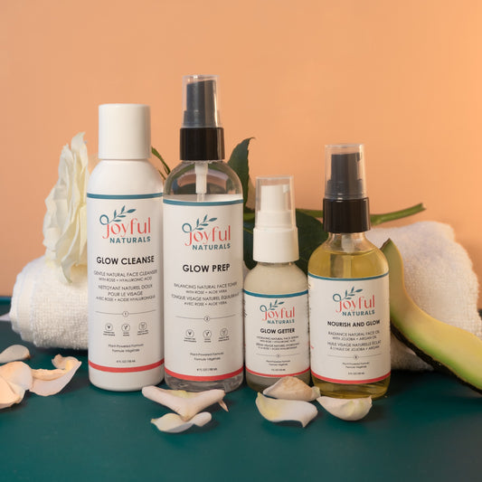 Joyful Naturals Glow System skincare routine set styled with fresh rose and towel for a daily self-care ritual.