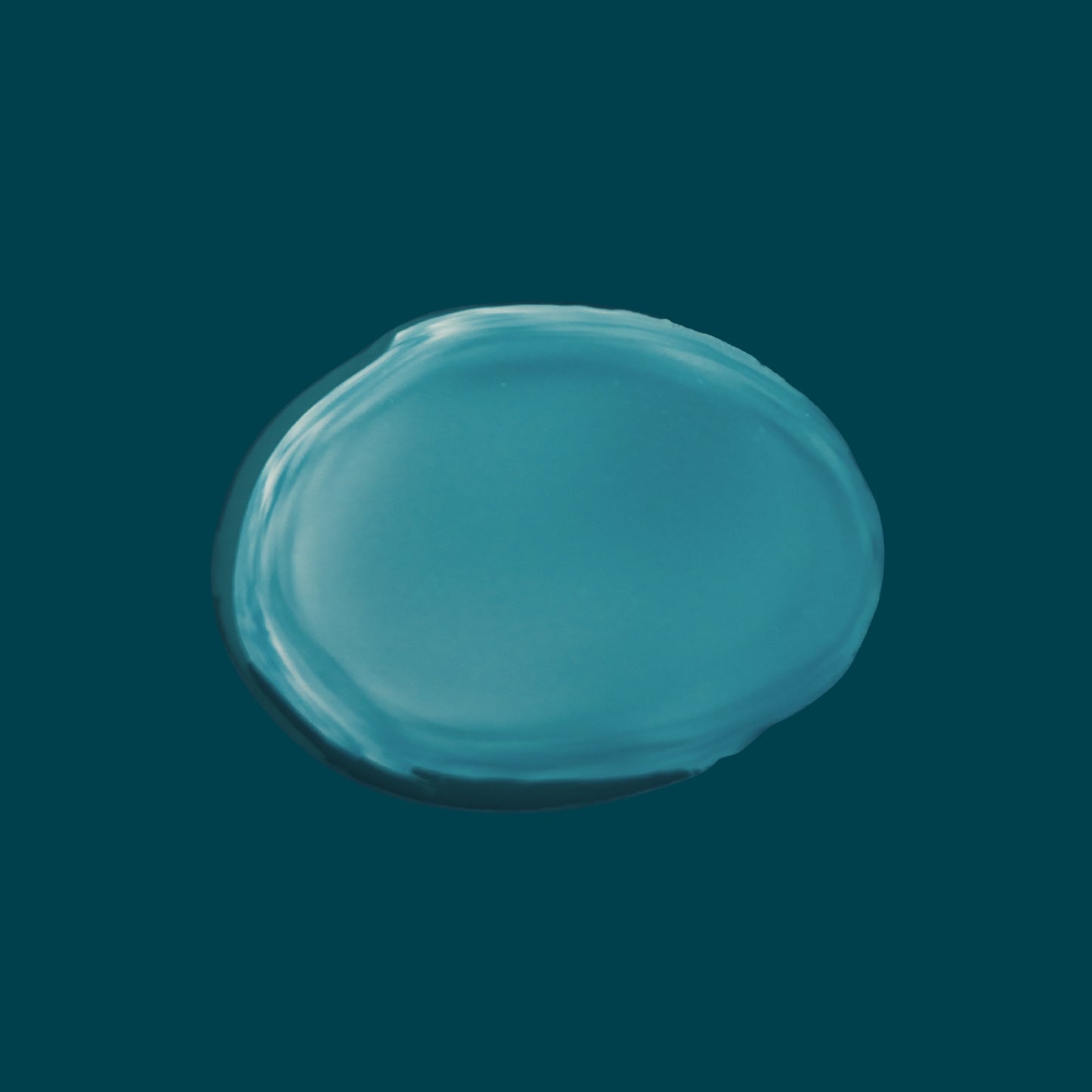 Lightweight non-greasy texture of Joyful Naturals jojoba face oil on teal background.