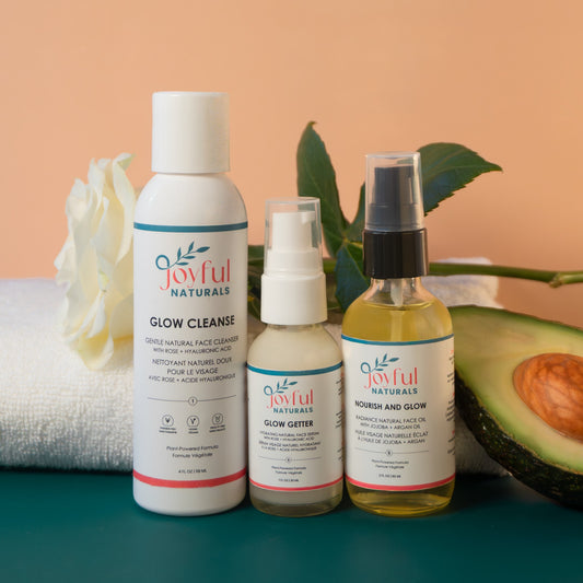 Minimalist skincare trio including glow serum styled with natural ingredients for a simple daily routine.
