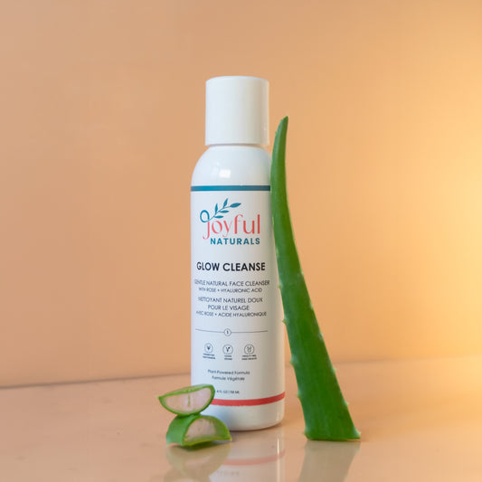 Gentle natural face cleanser bottle styled with aloe vera leaf showing hydrating ingredients.