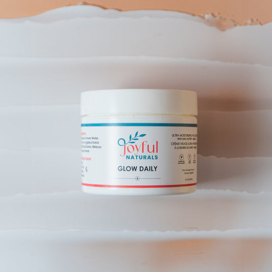 Rich daily face cream jar styled with rose petals showing deep nourishment texture.