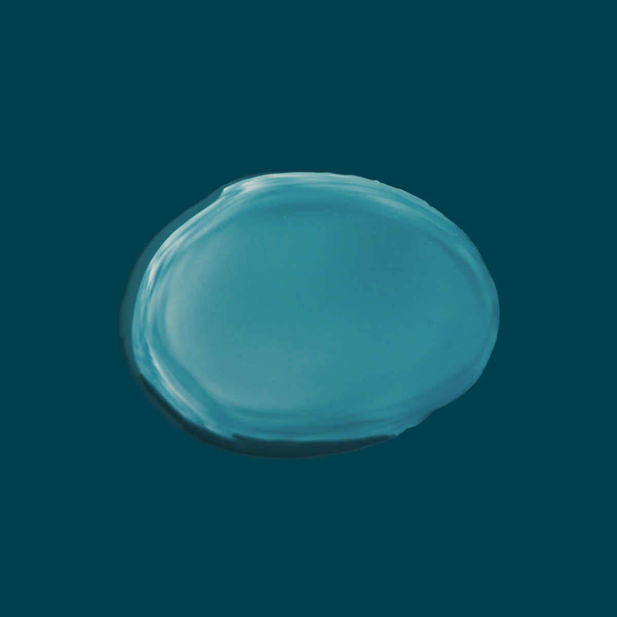 Lightweight non-greasy texture of Joyful Naturals jojoba face oil on teal background.