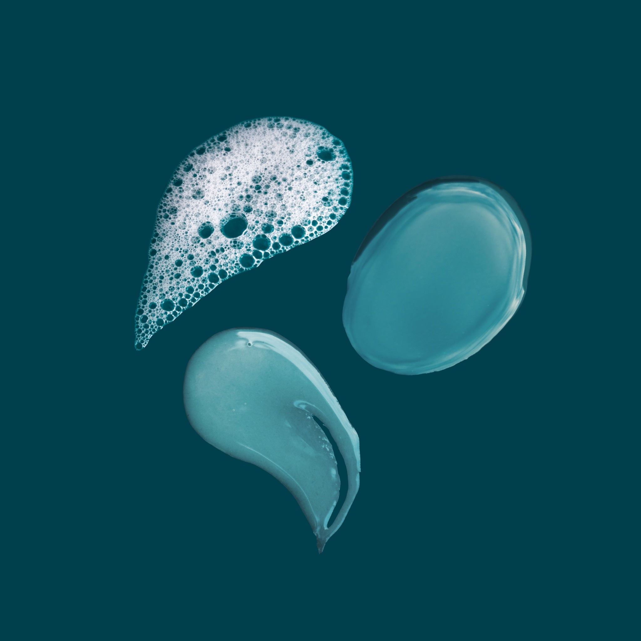 Texture swatches of the Simple Start kit showing cleanser foam, plumping serum gel, and face oil.